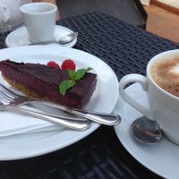 Raw vegan fruit cake with chocolate topping and spelt caffeine free coffee with soy milk  at LoVeg in Prague