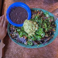 Muchos Nachos. No cheese. Add mushroom and rice. Hand for size reference. at Oscar's Cafe in Springdale