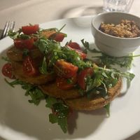 Cotoletta di melanzane su insalatina di pomodorini e rucola  at La Voglia in Malcesine