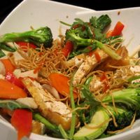 Vegetables stir-fried with mixed proteins and served on crispy noodles at Quan Bo De Cuisine Vegetarienne in Montreal