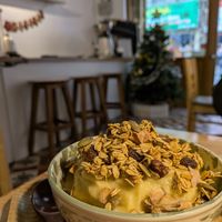 Banana and mango smoothie bowl made with oat milk at Dream Beans Coffee in Hanoi