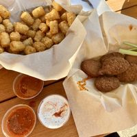 Tots, vegan ranch, cilantro lime wing sauce, and the nuggets (you toss in sauce yourself) at Fire on the Mountain in Portland