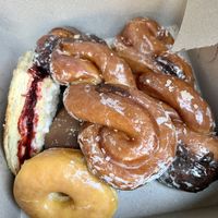 Raspberry turnover, cinnamon twists, glazed and a chocolate cream filled at the bottom.   at Ronald's Donuts in Las Vegas