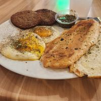 Over medium fried eggs, vegan sausage patties, chimichurri sauce, Cuban toast, lavender lemonade! at A Lo Vegano Orlando in Orlando