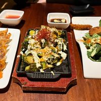 From left to right: gyoza with dipping sauce, brussel sprouts, and katsu with sauce.  at Tane Vegan Izakaya in Palo Alto