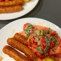 Chorizo "sausages" by Heura. I fried them and served with simple tomato salad and boiled potatoes. Simple vegan food always has rich taste 🤤 at La Sirena in Premia De Mar