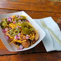 Juicy Vegan Weiner with house made chili, Daiya shreds, onions, and jalapeños. at Advice Booth in Portland