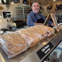 Owner with his daily baked sourdough breadd  at House of the Rising Buns in Pismo Beach