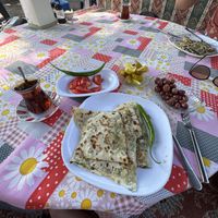Spinach gözleme with sides of olives, pickles and tomatoes   at Gözde Cafe in Mugla