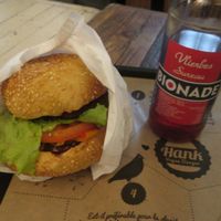 A burger with american dressing and an organic soft drink at Hank Cuisine Végétale - Archives in Paris