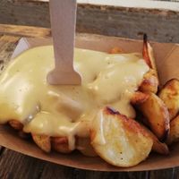 Melted cheese on fried potatoes at Hank Cuisine Végétale - Archives in Paris