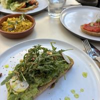 The avocado toast has SO much flavour, the other dishes pictured are the Spanish toast, a side of tofu scramble, and the chickpea omelette, which were all amazing as well!!  at Let It Bloom in Valencia