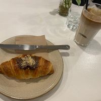 Vegan chocolate croissant and oat milk iced latte  at Let It Bloom in Valencia
