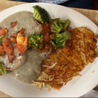 Vegan Biscuits and Gravy topped with Grilled Broccoli and Tomatoes with Hash Browns at Willalby's Cafe in Madison