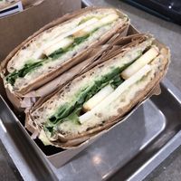 Sandwich with hummus, avocado, apple, cashew cheeze, and spinach  at Plants By Us in Helsinki