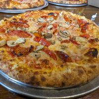 Hand toss crust, vegan cheese, mushrooms and roasted tomatoes. at Fire on Fifth in Peru
