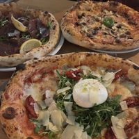 Top right pizza is topped vegan with vegan cheese, olives mushrooms, artichokes and vegan ham. Bottom one is topped with various cheeses. Top left is topped with beef ham. at Lausbub Pizza Napoletana - Nürnberg Ost in Nuremberg