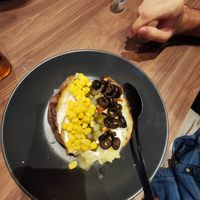 Potatoe filled with corn, pickles, tofu, black olives and vegan yogurt at Kumpir Brothers Leer in Leer