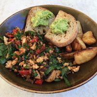 Tofu scramble (which comes with avocado on toast and some hot chips) at Invita Living Food in Melbourne