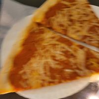 Blurry picture of vegan vodka sauce pizza slices at Vinnie's Pizzeria in Brooklyn