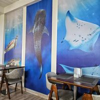 The cosy restaurant with ocean motifs. at Malaveli Restaurant  in Dhigurah