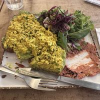 Avo toast with tofu scramble (partially eaten)  at Meo Cafe in Brighton