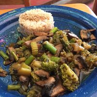Brown rice with mushrooms, broccoli and spinach sautéed in soy sauce at La Jícara Librespacio Cultural in Oaxaca