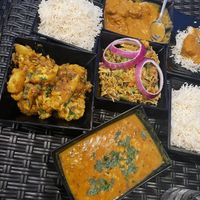 from left to right, top to bottom: basmati rice, chicken korma, aloo gobi, vegetable biryani, dal tadka  at Himalayan Kitchen  in Somerville