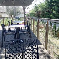 The peaceful outdoor seating area at the back of the restaurant, in a secluded and quiet garden at La Faim Des Haricots in Blagnac