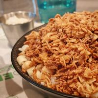 Kochari

A mixture of rice, pasta, brown lentils, chickpeas, tomato sauce, and fried onions. at Veganil in Paris