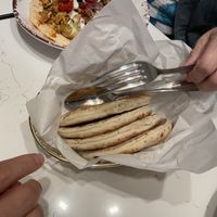 Side of pita bread (top of picture is hummus bowl with chicken (not vegan))  at Meddys in Kansas City