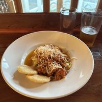 zucchini pasta with Impossible™️ ground beef marinara sauce and vegan cheese, with corn arepitas on the side  at Mi Mochima in Whitethorn
