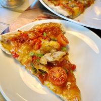 Sloce of "chicken" vegan pizza with Heura "pollo" and vegan cheese.
 at Pizzería Carlos in Barcelona