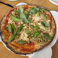 Cauliflower crust pizza on house red with plant based cheese with basil/green olives/pineapple  at Firebird Pizza  in Traverse City