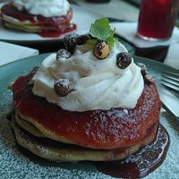 Lemon pancakes with strawberry jam, whipped cream, and roasted hazelnuts at Kafé Oransjeriet in Stavanger