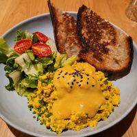 Scrambled tofu with salad, cale, bread, and hollandaise sauce at Kafé Oransjeriet in Stavanger