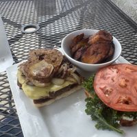 Deluxe burger.. and plantains. Party time. Excellent  at Kale Cafe Vegan Kitchen in Daytona Beach