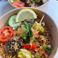 Foreground, vegan skewers (falafel and vegetables) with noodles, background non-vegan skewers. at Yummy Brochettes in Laval