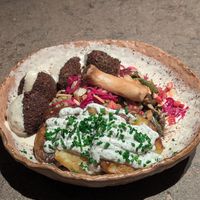 Miso bowl with falafel and truffle potatoes at Honest Greens in Valencia