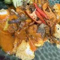 Closeup of soft tofu with curry sauce   at Begin Vegan Food in Chiang Mai