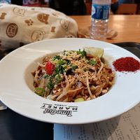Pad thai with chilli powder and peanuts for toppings.

Ingredients: spring onion, mushroom, cherry tomato, courgette, etc at Asian Lab in Lisbon