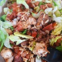 Closeup of burrito bowl with brown rice, tofu, pinto beans, and lettuce. at Moe's Southwest Grill in Monroeville