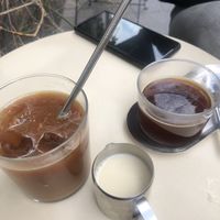 Iced decaf americano with oat milk and regular americano   at BOUCHE Specialty Coffee in Brussels