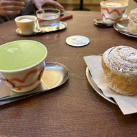 Foamy matcha with pea milk + cardamom roll  at BOUCHE Specialty Coffee in Brussels