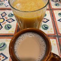 Oat milk chai and vegan mango lassi  at Annapurna's World Vegetarian Cafe in Santa Fe