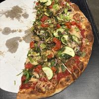 Large Veggie Pizza with vegan cheese (half eaten)!  at Geno D's Pizza - Market at 7th in Charlotte