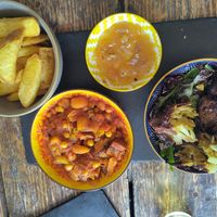 Chips, tagine, mango chutney and onion bhaji at Hop In Beer & Gin in Brecon