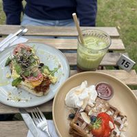Scrambled tofu toast, Belgian waffles with compote and almonds and strawberry matcha iced latte.  at VERDE in Malmo