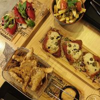 Stuffed bell peppers (left), chips with chimichurri (top), milanesas (middle) and KFC (bottom). at MEZZE in Granada