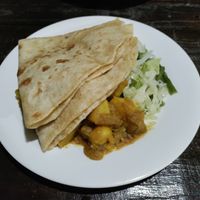 Huge roti with vegetables and potato curry at Indo Restaurant in Noord
